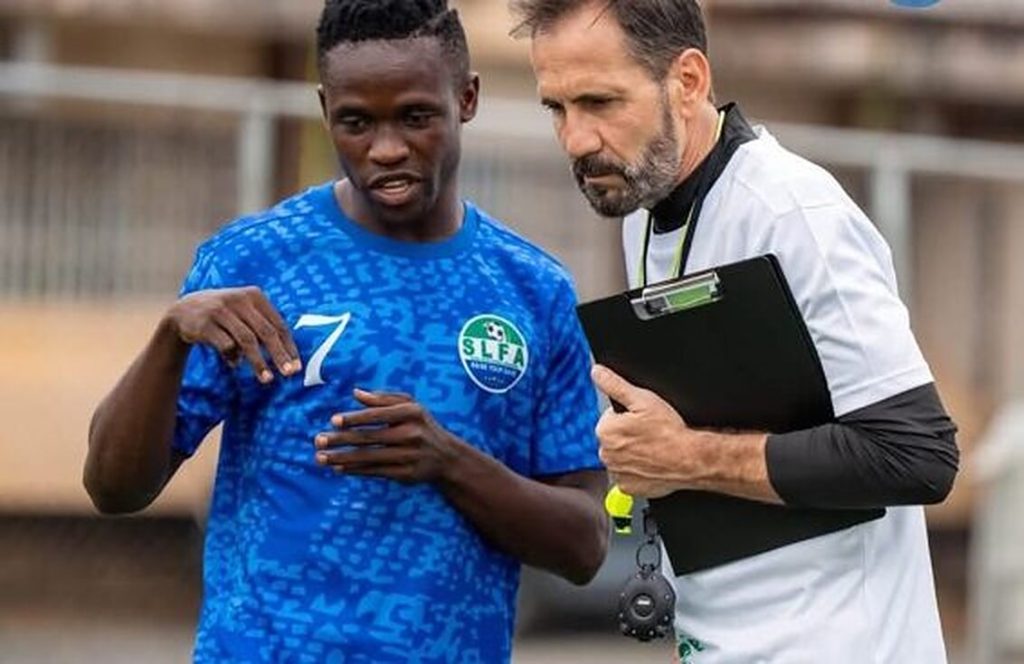 A Sierra Stars U17 player receives instructions from the coaching staff