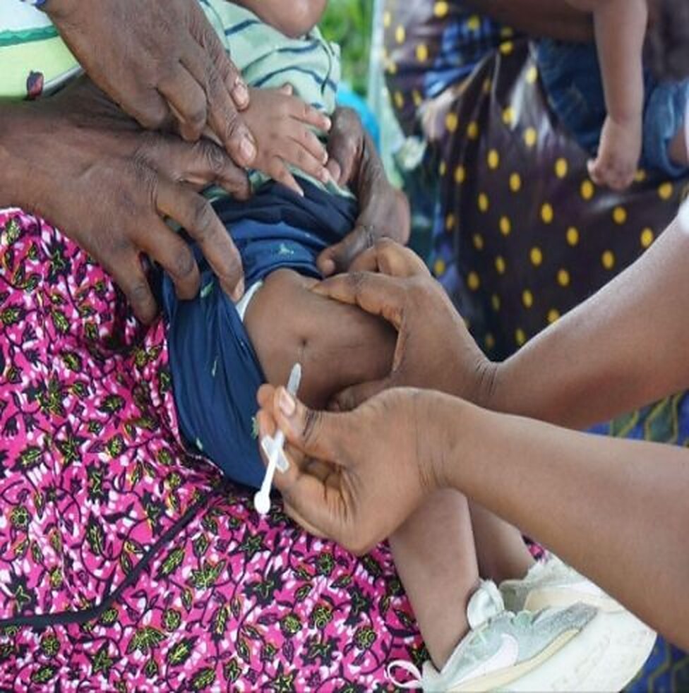 A child receives a vaccination during the 300 Days Campaign